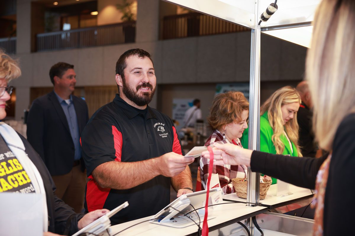 An attendee receives their on-demand printed badge at the MSBA Annual Conference 2024