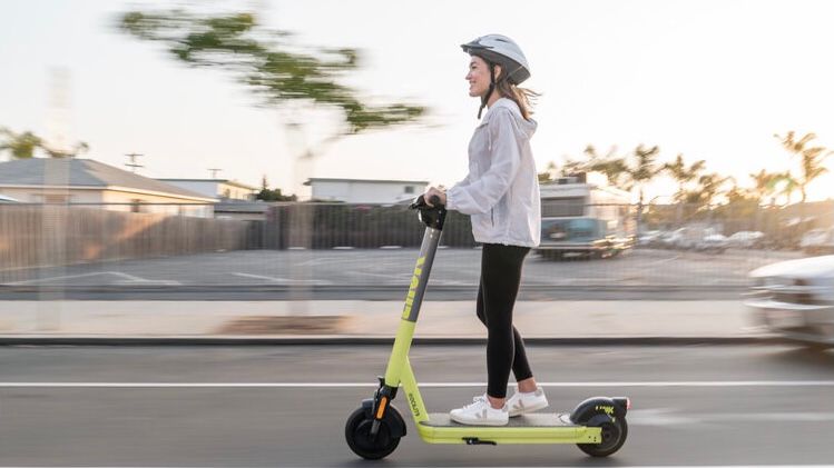 Woman riding on a scooter.