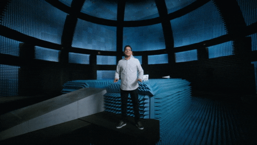 Man standing in a futuristic blue room   speaking