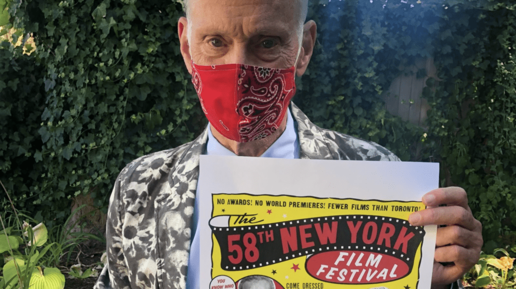 Picture of masked man holding a poster for The 58th New York Film Festival
