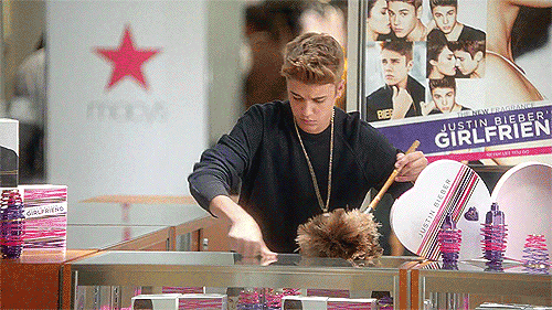 Justin Bieber dusting a display counter full of his "Girlfriend" perfume at Macy's