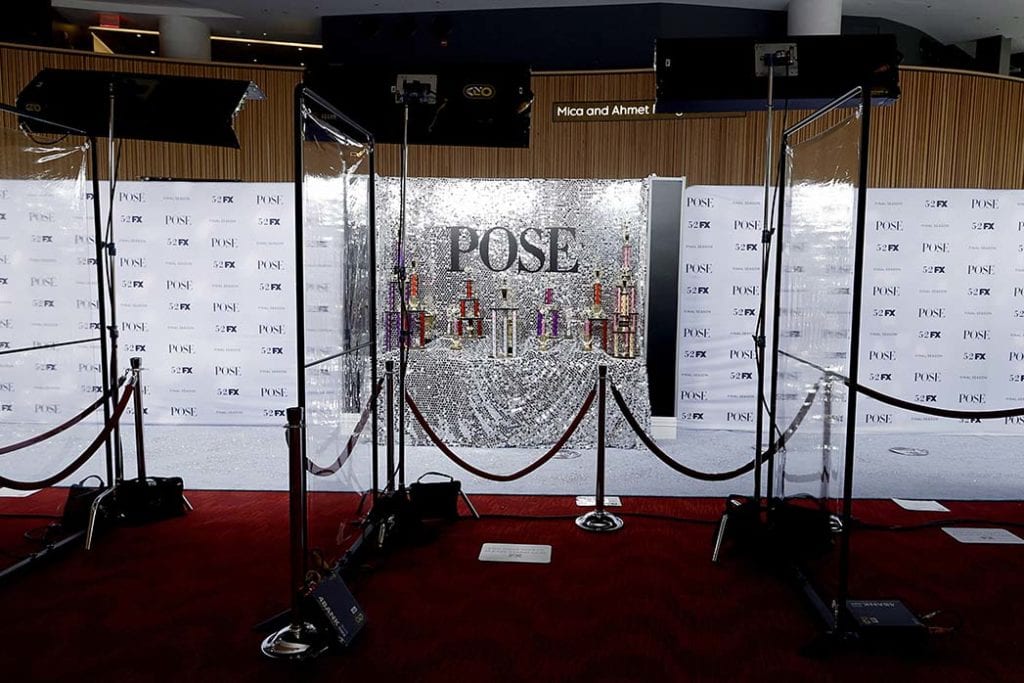 Plastic partitions set up at the POSE in-person premiere to keep photographers away from their subjects for safety