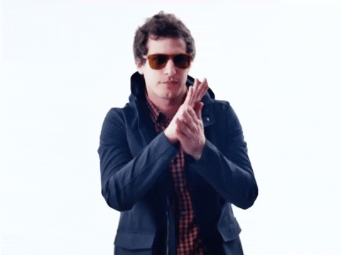 GIF of Andy Samberg rubbing his hands together 