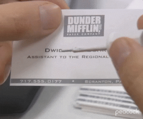 GIF of Dwight Schrute whiting out his business card's title 