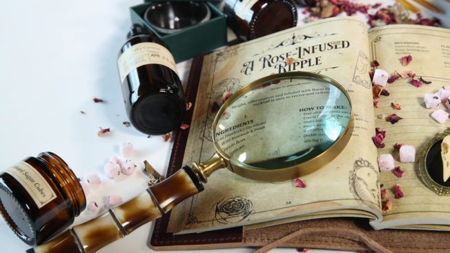 Old Victorian themed book with magnifying glass laying on top of it