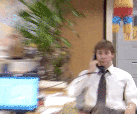 GIF from The Office zooming into Jim's face while he hangs up the phone