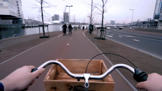 first person POV GIF of man riding a bike through Amsterdam
