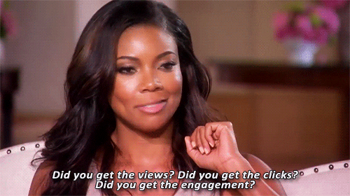 Woman talking about clicks and engagement in front of audience.